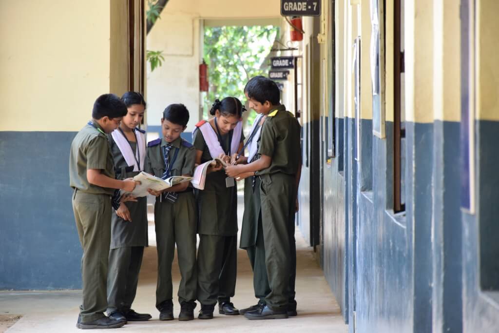 Students reading books between classes